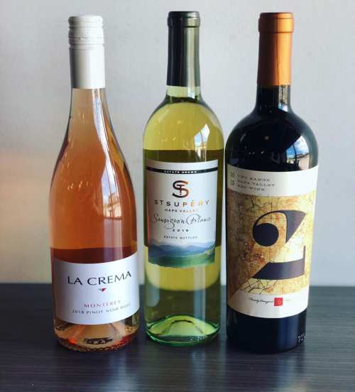 Three wine bottles: a rosé, a Sauvignon Blanc, and a red wine, displayed against a neutral background.