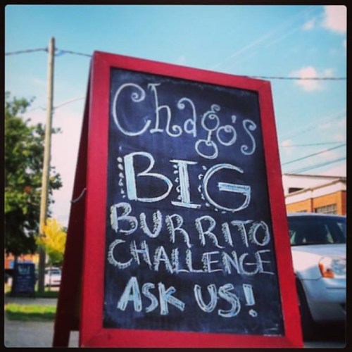 Chago's sign advertising a "Big Burrito Challenge" with a call to action to ask for details.