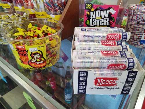 A display of candy including Mary Jane treats and Necco wafers in a store setting.