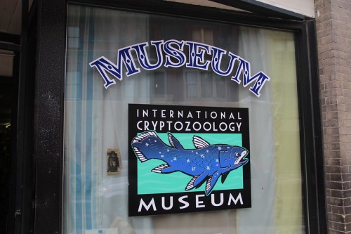 Sign for the International Cryptozoology Museum featuring a stylized fish illustration.
