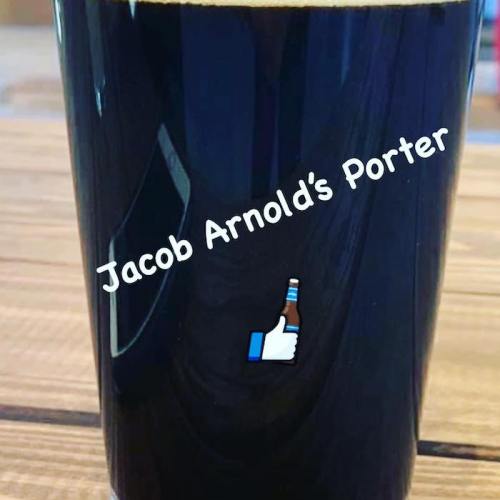 A dark beer in a glass with the text "Jacob Arnold's Porter" and a thumbs-up emoji.