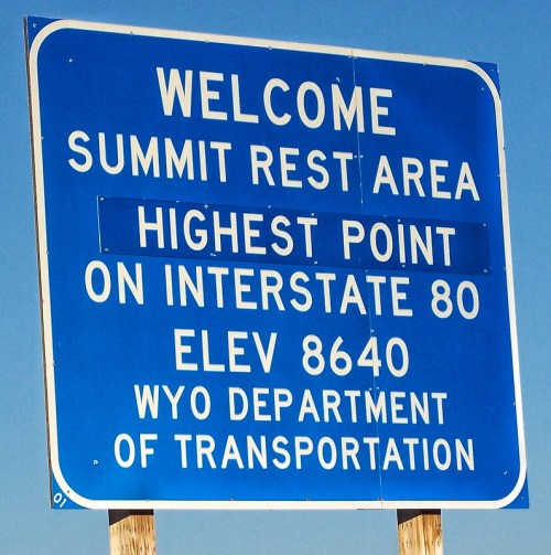 Blue sign welcoming visitors to the Summit Rest Area, noting it's the highest point on Interstate 80 at 8640 feet.