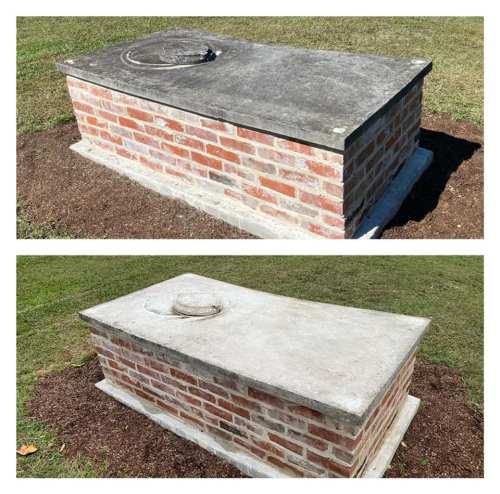 A brick and concrete tomb or grave marker, shown from two angles, set in a grassy area.