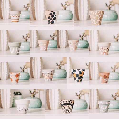 A collage of decorative plant pots with various patterns and colors displayed on a shelf.