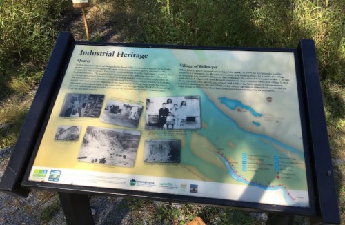 Sign about the industrial heritage of a quarry and the village of Billmeyer, featuring historical photos and information.