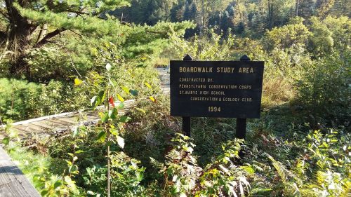 Sign for the Boardwalk Study Area, constructed by the Pennsylvania Conservation Corps in 1994, surrounded by greenery.