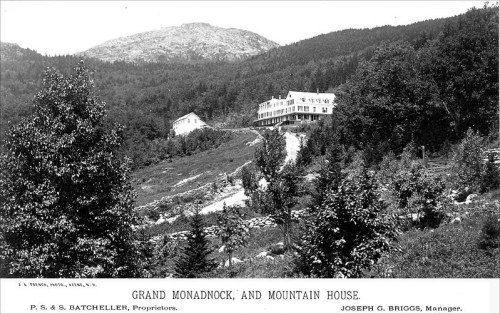 Black and white photo of Grand Monadnock and Mountain House, surrounded by trees and mountains. Historical image.