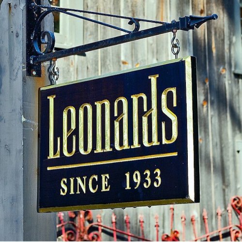 Sign for "Leonards" with the text "Since 1933" displayed prominently, hanging from a decorative bracket.