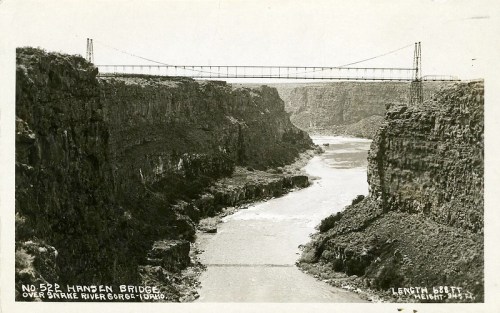 Black and white postcard of Hansen Bridge spanning the Snake River Gorge in Idaho, with rocky cliffs on either side.
