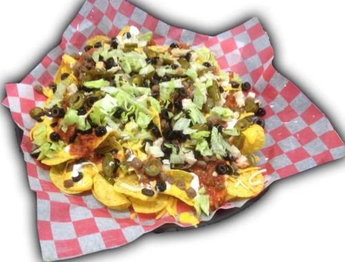 A colorful plate of nachos topped with lettuce, olives, salsa, and sour cream, served in a red and white checkered basket.