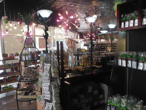 A cozy store interior filled with shelves of products, colorful lights, and a welcoming atmosphere.