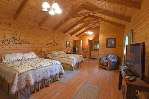 Cozy wooden cabin interior with two beds, a TV, and rustic decor, featuring warm lighting and a welcoming atmosphere.