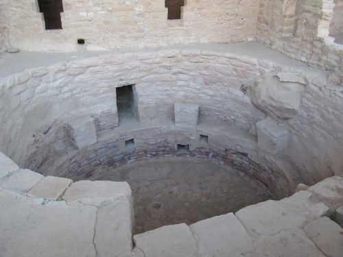 Ancient stone structure with a circular, tiered interior and small openings in the walls.