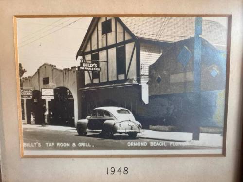 Black and white photo of Billy's Tap Room & Grill in Ormond Beach, Florida, with a vintage car parked outside, dated 1948.