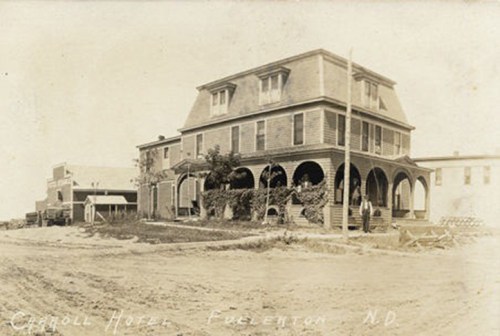 Historic black-and-white photo of Carroll Hotel in Fullerton, ND, featuring a large, multi-story building.