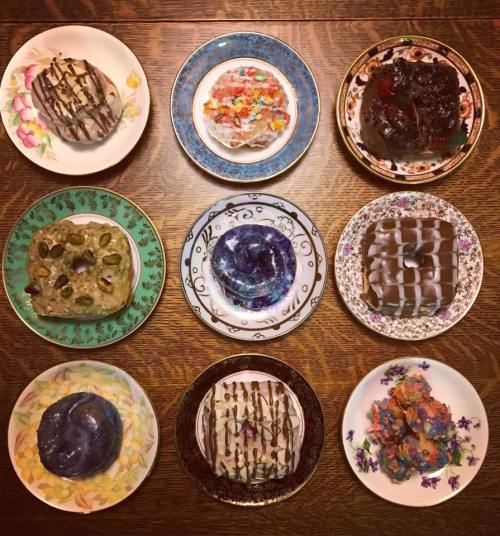 A colorful assortment of desserts arranged on decorative plates, featuring various shapes and toppings.
