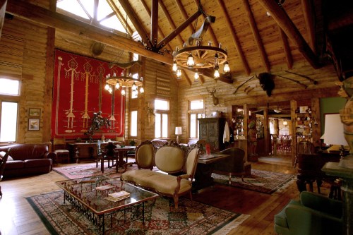 Cozy rustic living room with wooden beams, vintage furniture, and decorative rugs, featuring a warm, inviting atmosphere.