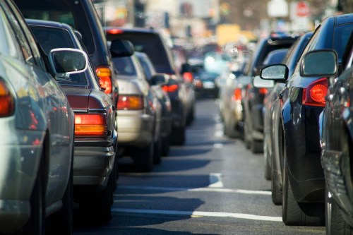 Traffic jam with various cars lined up on a busy street, creating a congested scene.