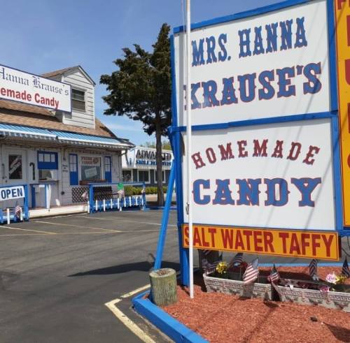 Signage for Mrs. Hanna Krause's Homemade Candy, featuring a prominent display for saltwater taffy outside a candy shop.