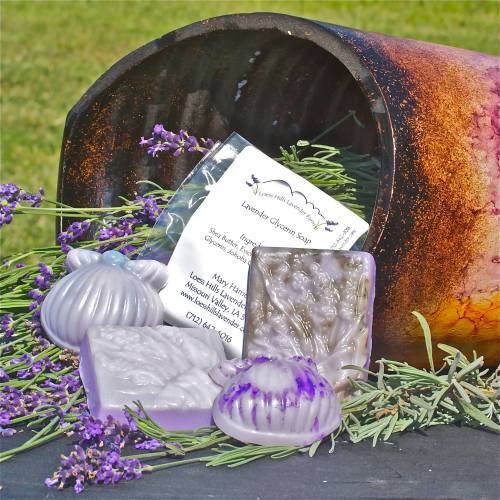 Lavender glycerin soaps in various shapes, surrounded by lavender sprigs and a product card, with a rustic background.