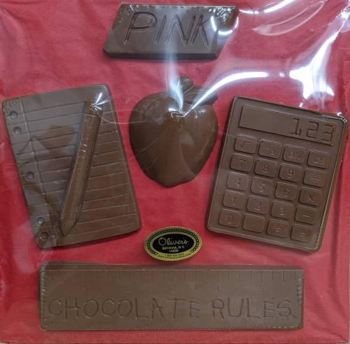 A collection of chocolate shapes including a notebook, ruler, apple, calculator, and the phrase "Chocolate Rules."