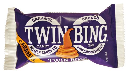 A purple candy wrapper featuring the "Twin Bing" logo and images of caramel and crunch elements.