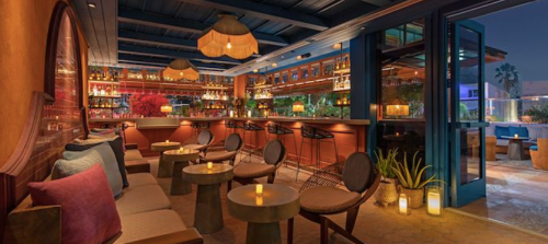 Cozy bar interior with warm lighting, stylish seating, and a vibrant atmosphere, featuring a well-stocked bar.
