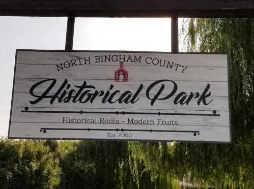 Sign for North Bingham County Historical Park, featuring the text "Historical Roots - Modern Fruits," established in 2000.