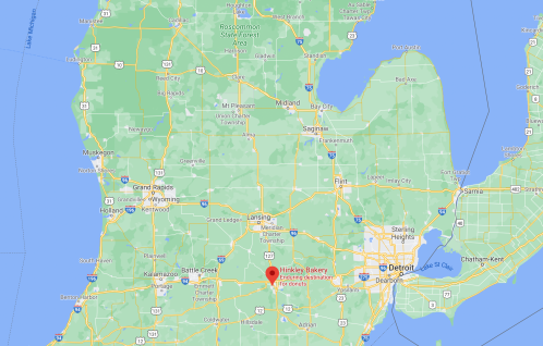 Map of Michigan highlighting Hinkley Bakery as a destination for donuts, with surrounding cities and landmarks.