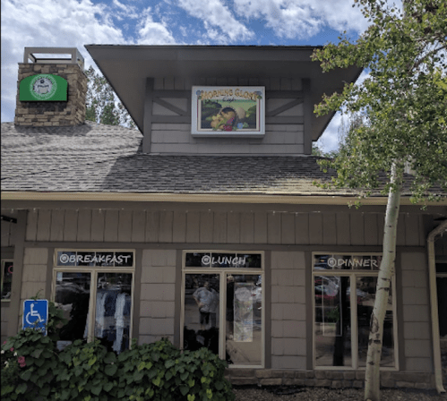 A restaurant building with a sign reading "Morning Glove" and windows displaying "Breakfast," "Lunch," and "Dinner."