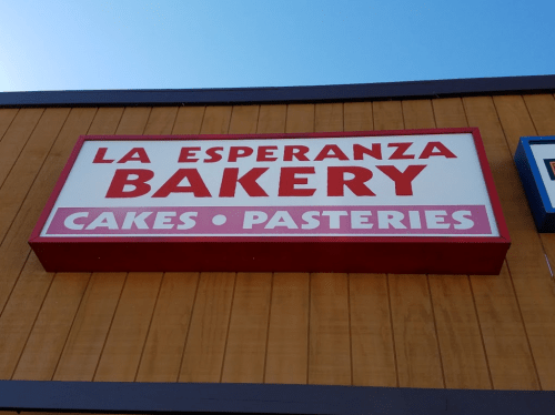 Sign for "La Esperanza Bakery" featuring the words "Cakes" and "Pastries" in bold letters.