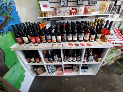 A display shelf filled with various bottles of wine, showcasing different labels and colors.