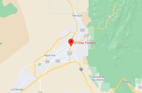 Map showing the location of "El Chile Toreado" in Tesuque, New Mexico, near major highways and surrounding areas.