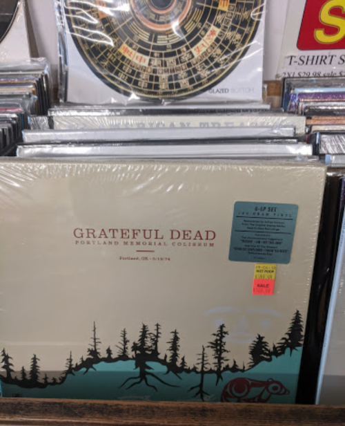 Album cover for Grateful Dead's concert at Portland Memorial Coliseum, featuring a forest and bear design.