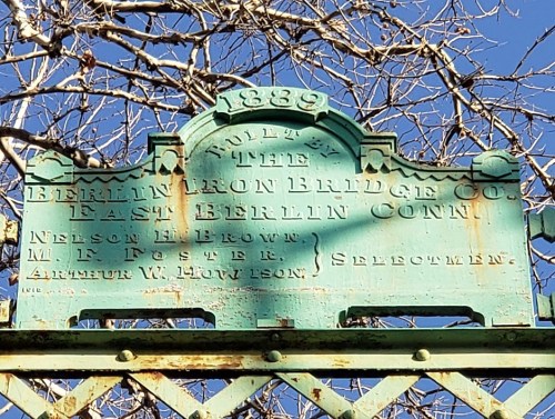 Weathered sign from 1839, reading "Built by the Berlin Iron Bridge Co., East Berlin, Conn." with names of officials.