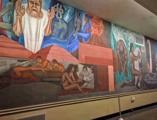 A colorful mural depicting various human figures and scenes, including abstract shapes and historical themes.