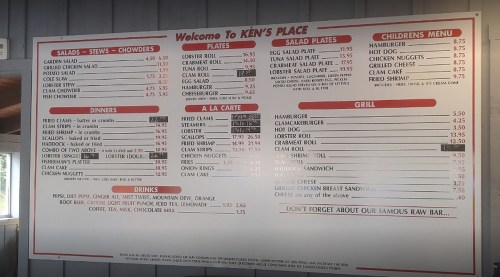 Menu board for Ken's Place featuring salads, stews, chowders, plates, dinners, grill items, and drinks.