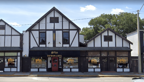 Exterior of Billy's Tap Room & Grill, featuring a Tudor-style building with black and white accents and large windows.