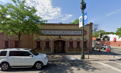 Exterior view of the Black Forest Inn, featuring a vintage facade and a white SUV parked in front.