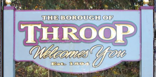 Sign for the Borough of Throop, welcoming visitors, established in 1894.