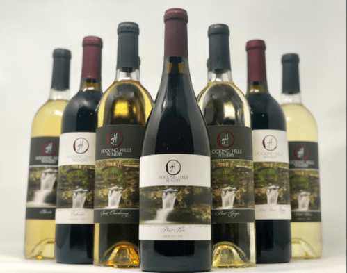 A selection of Hocking Hills Winery wines, featuring various bottles of red and white wine against a neutral background.