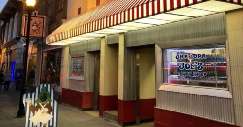 Neon lights glow above Grandpa Joe's Candy Shop at dusk. A classic stop for a colorful Ohio evening.