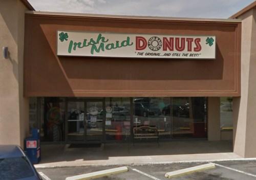 Exterior of a donut shop with a sign reading "Irish Maid Donuts" and a storefront with large windows.