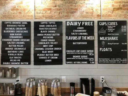Menu board featuring desserts and flavors, including coffee brownies, ice cream, and dairy-free options.