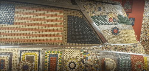 A colorful display of buttons and bottle caps arranged to form patterns, including an American flag and various designs.