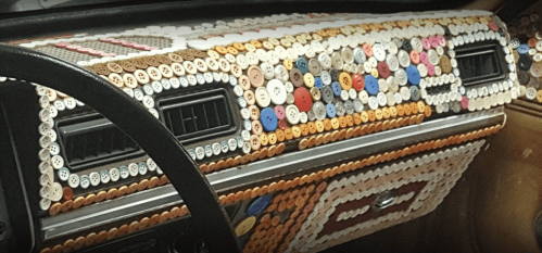 A car dashboard creatively decorated with an array of colorful buttons.