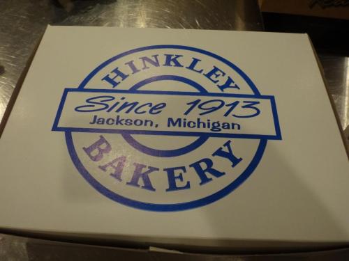A white bakery box with a blue logo that reads "Hinkley Bakery Since 1913 Jackson, Michigan."
