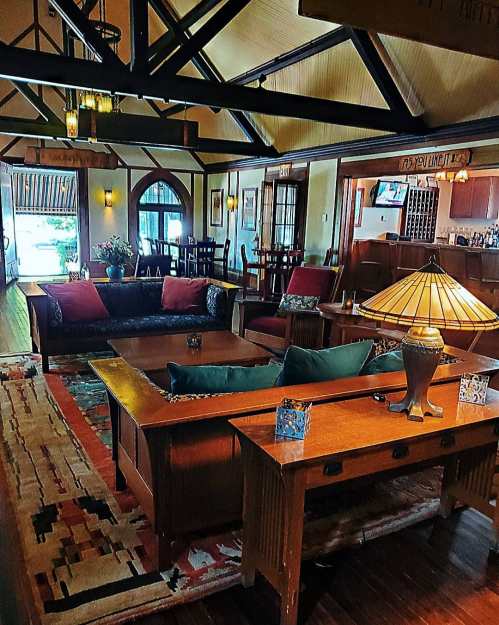 Cozy living room with wooden beams, comfortable seating, a coffee table, and a warm ambiance.