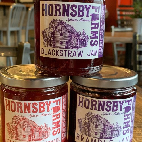 Two jars of Hornsby Farms jam, labeled "Blackstraw Jam" and "Bramble Jam," with a rustic design.