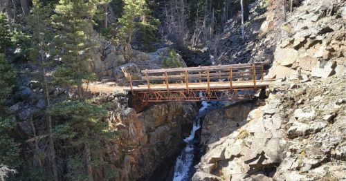 A trail in Elk Mountain, Wyoming, with a bridge